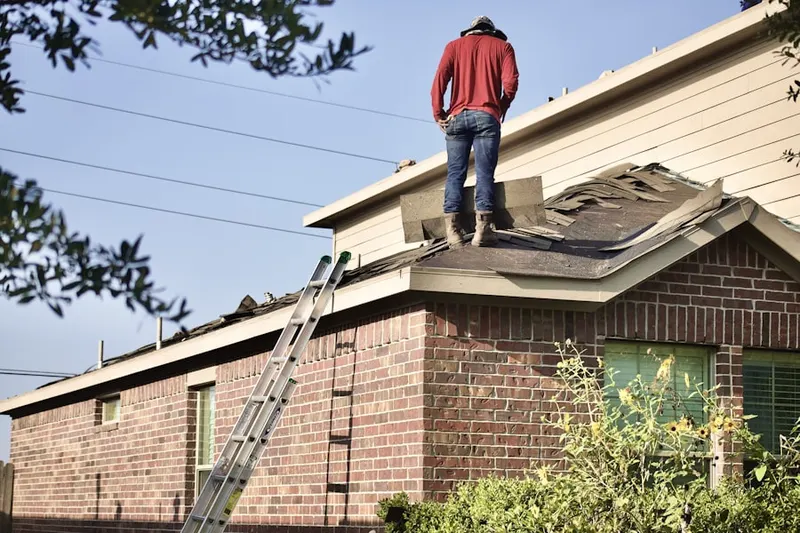 Professional roofer working on a residential roof in Pine Grove Terrace